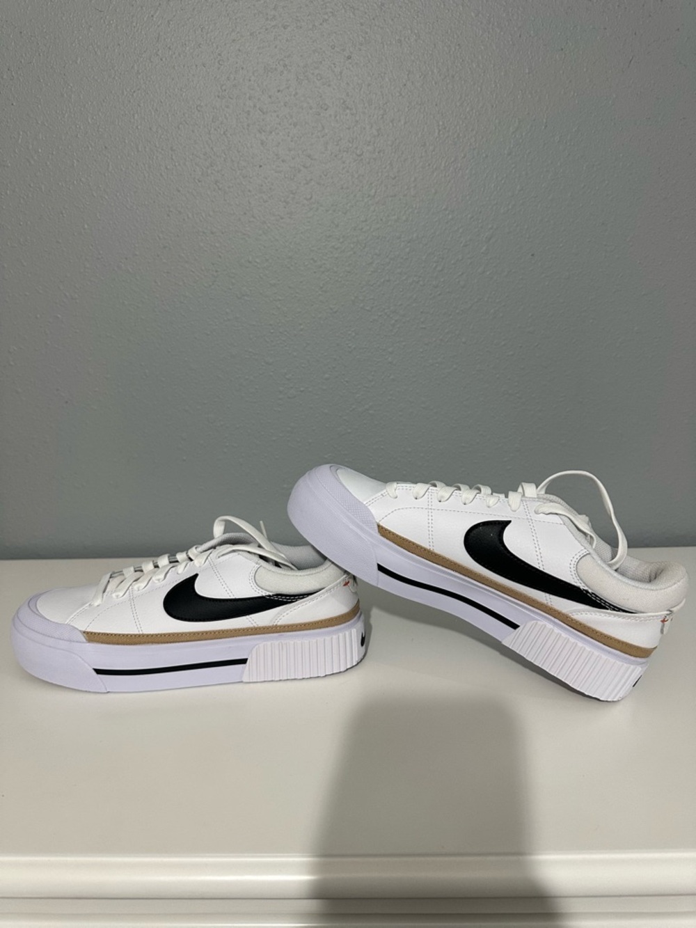 Nike White Platform Sneakers with Black Swoosh and Gold Trim